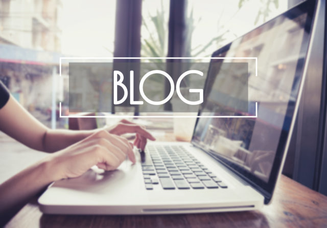 business hand typing on a laptop keyboard with blog blogging hom